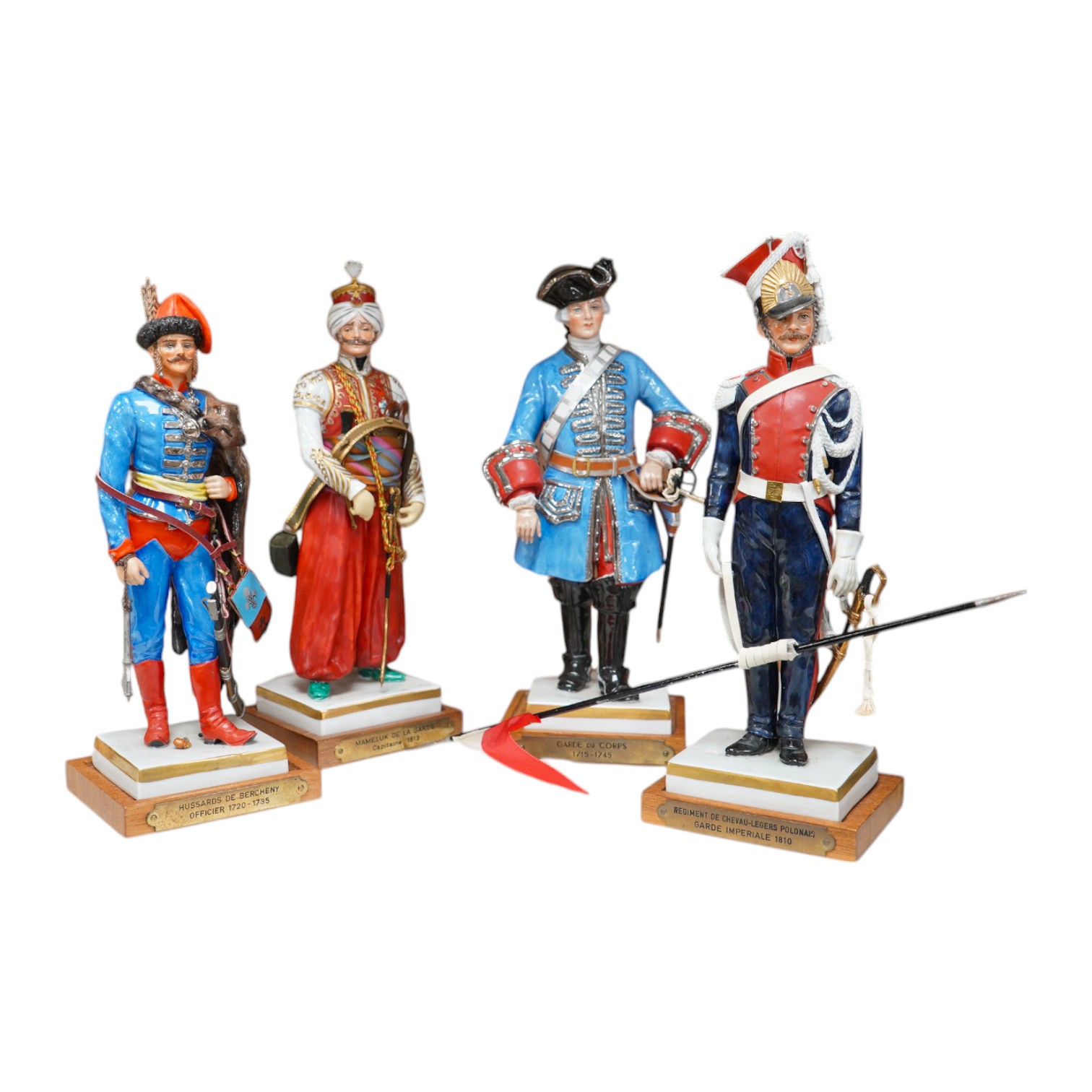 A set of four French porcelain military figures on stands to include ‘Hussards De Bercheny Officer’ and ‘Garde Du Corps’, largest 26cm high. Condition - mostly good condition with some minor losses